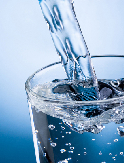 Pouring Water Into Glass On Blue Background
